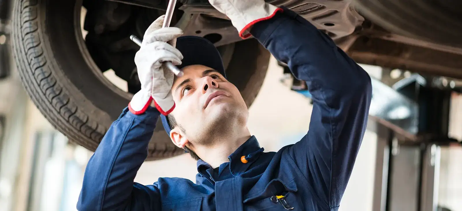 ASE Certified mechanic performing auto repair at Uptown Car Care Center Houston
